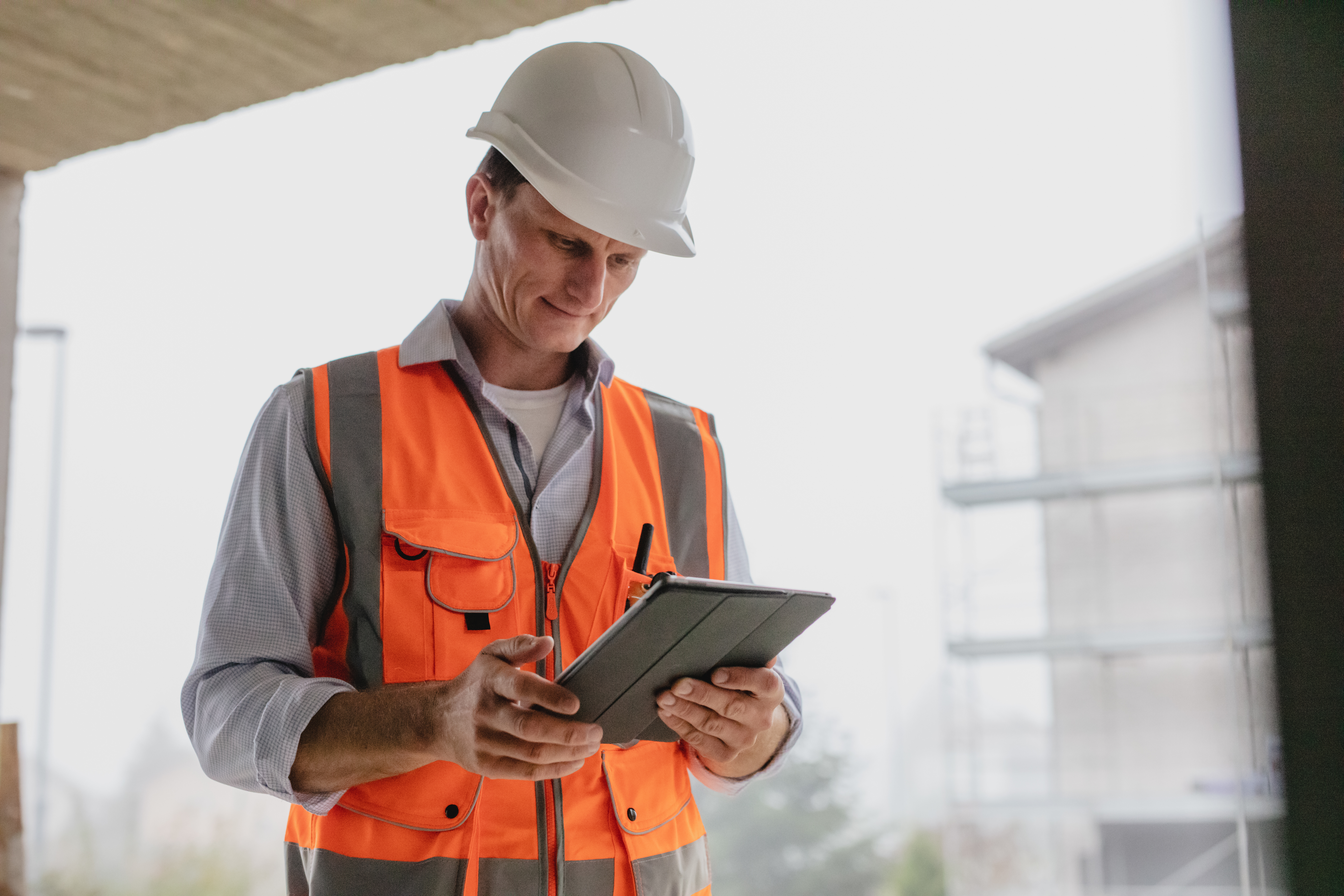 Architect using digital tablet at under construction site